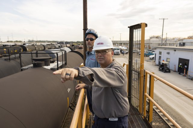 workers handling tank storage