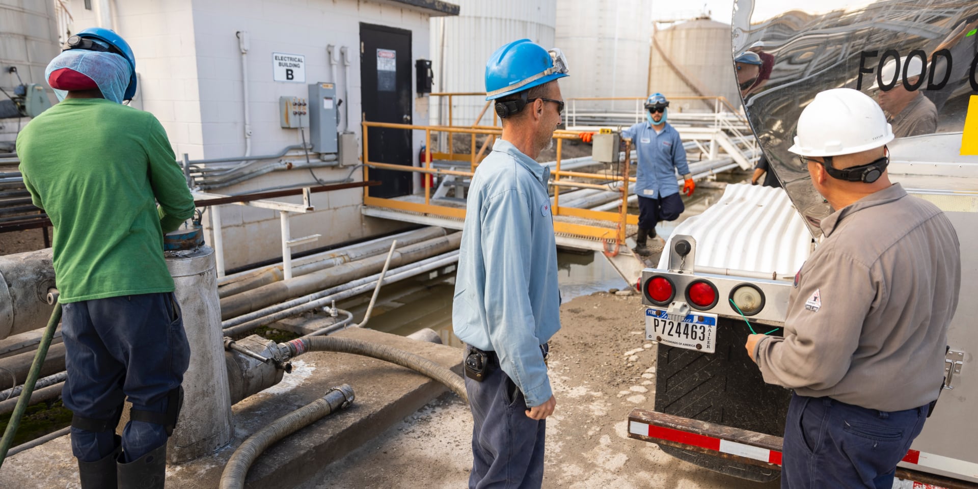 workers transloading tank